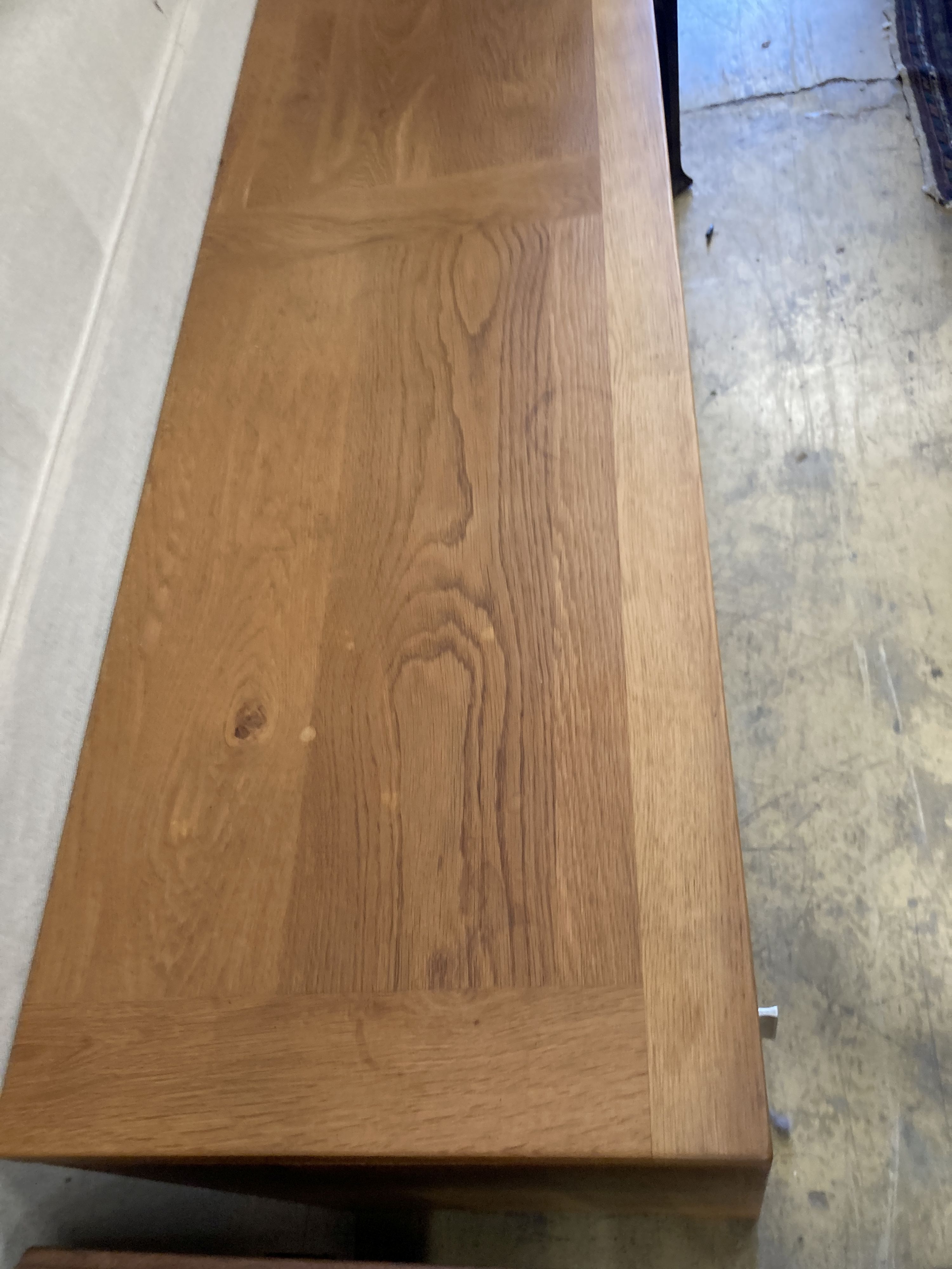 A contemporary light oak sliding door sideboard, length 178cm, depth 50cm, height 78cm